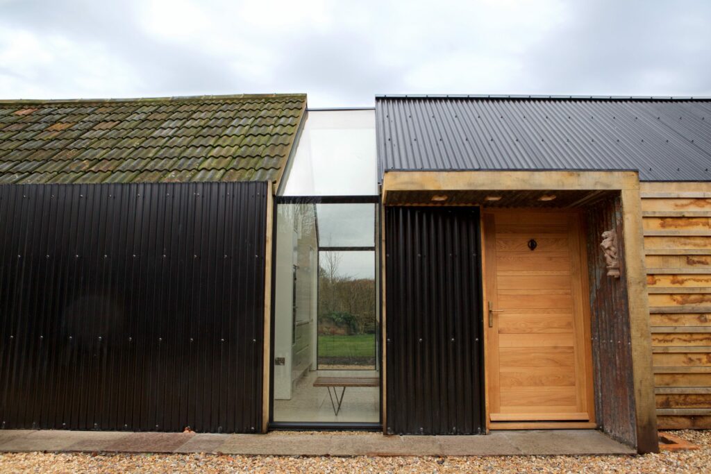 porch structure for old and new rural outbuildings connected by glass