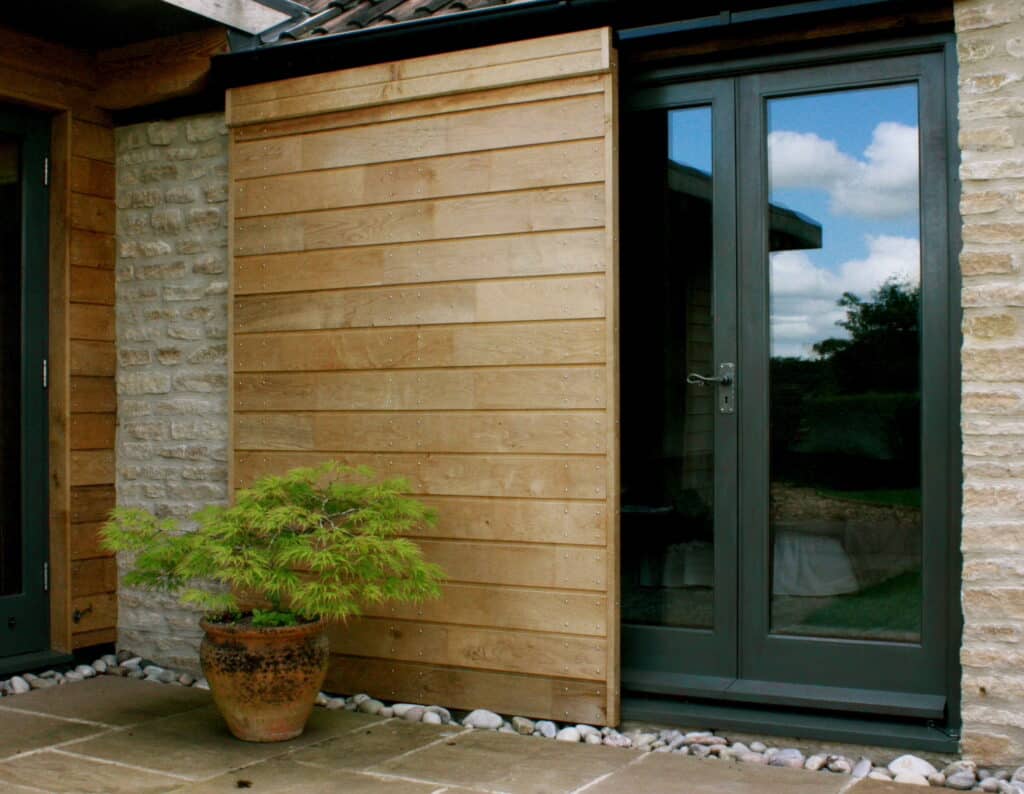 sliding oak shutter over glazed door