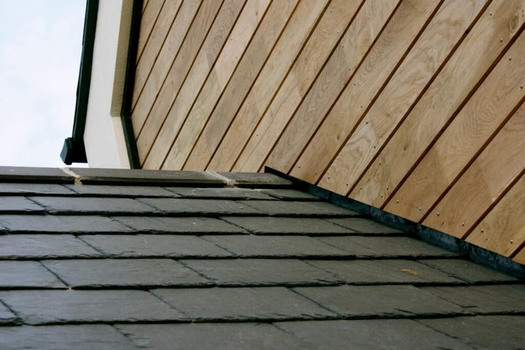 slate tile roof and wooden cladding eco self build house architecture