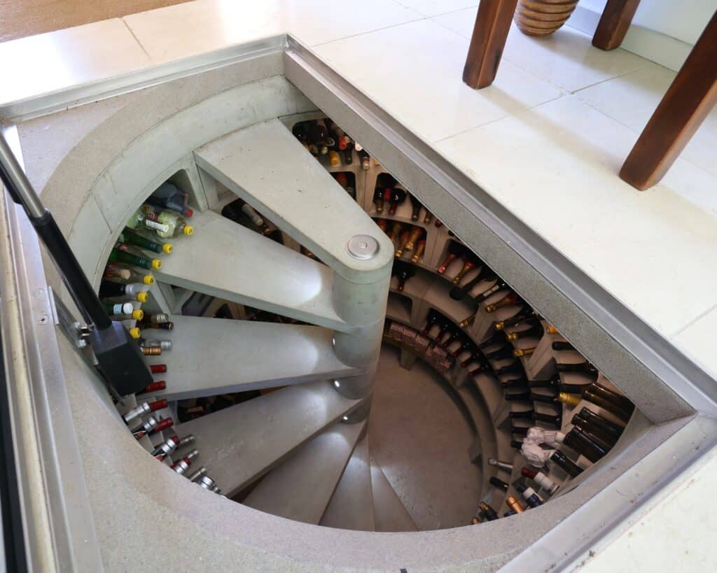 Underground spiral staircase wine cellar, thatch new build architecture