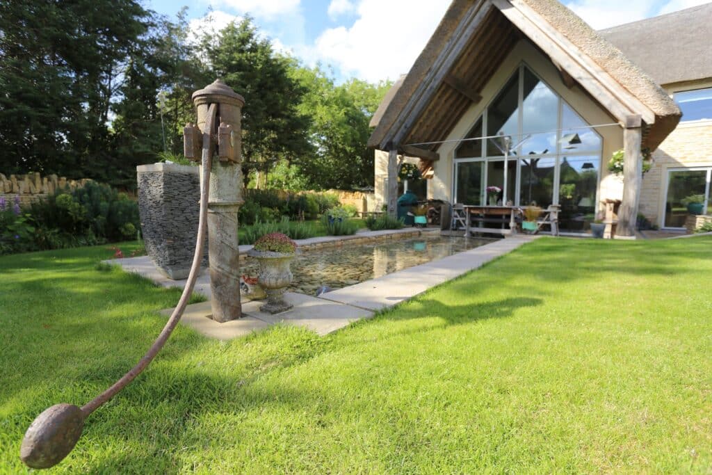 landscaped garden with reflection pool and water pump contemporary eco-house