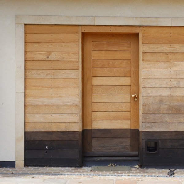 timber panelled front door and surrounding entrance structure
