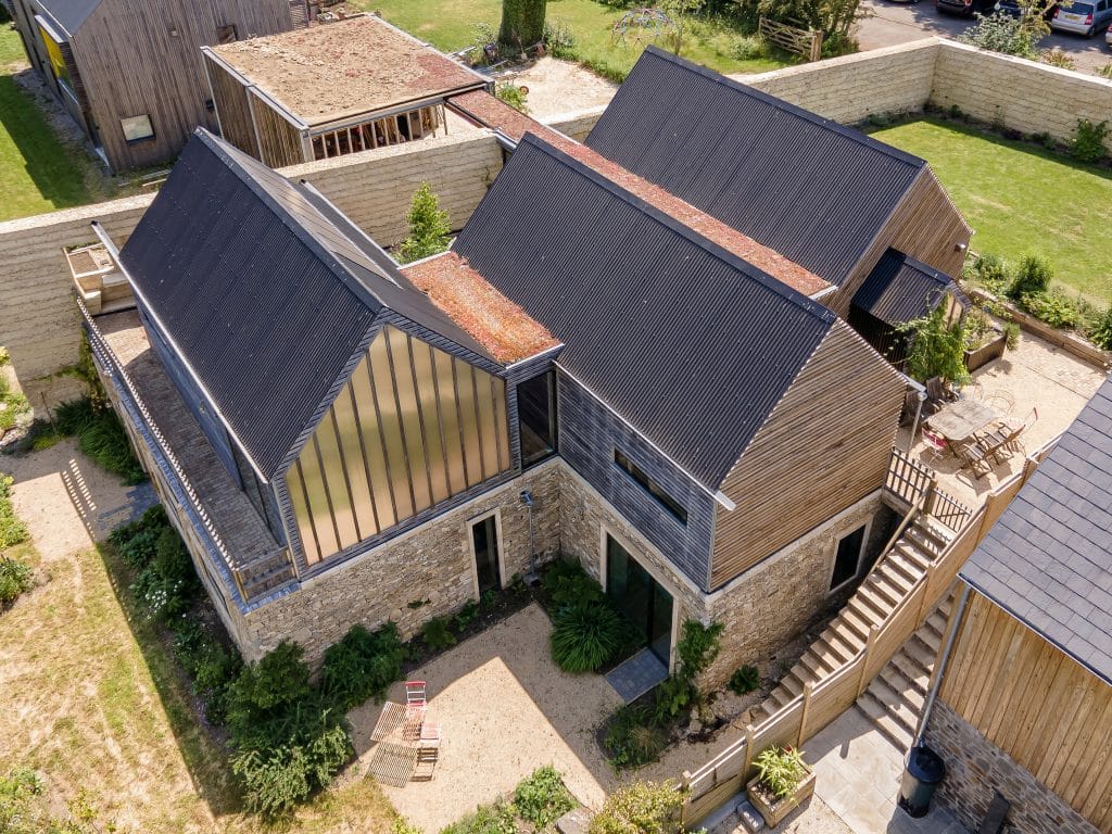An Eco New-Build House featuring a stone wall and a stone wall.